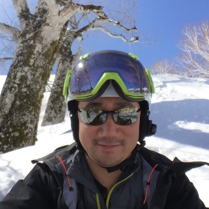 Dave Chen in ski gear under snowy birch trees at Kagura, Japan